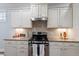 Kitchen with gas range, granite counters, and stainless steel hood at 1135 Rosepine Dr, Cary, NC 27519