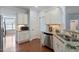 Bright kitchen with granite counters, stainless steel appliances, and a large doorway at 1135 Rosepine Dr, Cary, NC 27519