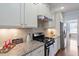 Kitchen with granite counters, stainless appliances, and gas range at 1135 Rosepine Dr, Cary, NC 27519