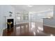 Open-concept living area with hardwood floors, fireplace, and access to the kitchen at 1135 Rosepine Dr, Cary, NC 27519