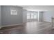 Spacious living room featuring hardwood floors and bright natural light from multiple windows at 1135 Rosepine Dr, Cary, NC 27519