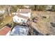 Aerial back view of the two-story building showing the deck, outbuildings, and roof at 120 Lake Orange Rd, Hillsborough, NC 27278