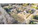 Drone's-eye view of rural homes along a winding road, complete with outbuildings and serene surroundings at 120 Lake Orange Rd, Hillsborough, NC 27278