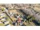 An aerial view of a rural property featuring several outbuildings and mature trees at 120 Lake Orange Rd, Hillsborough, NC 27278