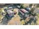 Aerial view of a charming country home with multiple outbuildings, showcasing a unique and spacious property at 120 Lake Orange Rd, Hillsborough, NC 27278