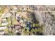 This aerial shot reveals a rural residence with a collection of diverse outbuildings set among trees at 120 Lake Orange Rd, Hillsborough, NC 27278