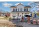 Two-story home featuring light colored siding, dark shutters, and manicured landscaping at 120 Lake Orange Rd, Hillsborough, NC 27278