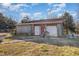 Exterior view of a weathered detached garage building with two bays and yard at 120 Lake Orange Rd, Hillsborough, NC 27278