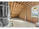 Spacious unfinished attic area, showcasing framing, insulation, and a window at 1403 Antioch Church Rd, Timberlake, NC 27583