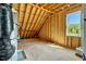 Unfinished attic displaying framing and a window showcasing the potential for conversion at 1403 Antioch Church Rd, Timberlake, NC 27583
