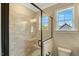 Modern bathroom features a tiled shower with glass door and sleek, black hardware at 1403 Antioch Church Rd, Timberlake, NC 27583
