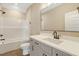 Modern bathroom featuring gray cabinets, double sinks, and a combination shower and tub at 1403 Antioch Church Rd, Timberlake, NC 27583