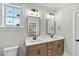 Bathroom boasts double vanity with modern fixtures and a view of a walk-in closet at 1403 Antioch Church Rd, Timberlake, NC 27583