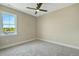 Inviting bedroom bathed in sunlight, featuring plush carpeting and a modern ceiling fan at 1403 Antioch Church Rd, Timberlake, NC 27583