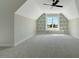 A light-filled bedroom is complimented with built-in shelving and plush carpeting at 1403 Antioch Church Rd, Timberlake, NC 27583