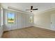 Bright bedroom featuring hardwood floors, a ceiling fan, and large windows that let in natural light at 1403 Antioch Church Rd, Timberlake, NC 27583