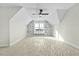 Bright bonus room with vaulted ceiling, built-in shelving, and ceiling fan at 1403 Antioch Church Rd, Timberlake, NC 27583
