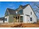 Exterior view of a green and white home showcasing the entrance and well-manicured yard at 1403 Antioch Church Rd, Timberlake, NC 27583