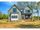 Inviting two-story home showcasing a modern color scheme and well-manicured landscaping at 1403 Antioch Church Rd, Timberlake, NC 27583