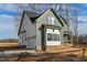 Side view of a two-story home with a two-car garage, white siding and a quaint front porch at 1403 Antioch Church Rd, Timberlake, NC 27583