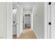 Hallway view with an open closet/pantry, bathroom, and wood-look flooring, connecting spaces at 1403 Antioch Church Rd, Timberlake, NC 27583