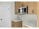 Modern kitchen with gray subway tile backsplash, stainless steel microwave, and shaker style cabinets at 1403 Antioch Church Rd, Timberlake, NC 27583