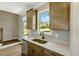 Bright kitchen with stainless dishwasher, sink, wood cabinets, and a scenic view at 1403 Antioch Church Rd, Timberlake, NC 27583