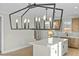 Bright kitchen features a large island with white countertop and unique light fixture at 1403 Antioch Church Rd, Timberlake, NC 27583