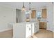 Kitchen featuring a large white island with a white countertop, shaker-style cabinets, and pendant lights at 1403 Antioch Church Rd, Timberlake, NC 27583