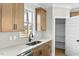 Well-lit kitchen features natural wood cabinets, stainless steel appliances and butler's pantry at 1403 Antioch Church Rd, Timberlake, NC 27583