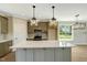 Modern kitchen with island seating, stainless appliances, and stylish pendant lights at 1403 Antioch Church Rd, Timberlake, NC 27583