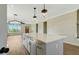 Kitchen features a quartz island, pendant lighting, stainless appliances, and open to the living room at 1403 Antioch Church Rd, Timberlake, NC 27583