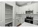 Modern kitchen with white cabinets, quartz countertops and stainless steel appliances at 1403 Antioch Church Rd, Timberlake, NC 27583