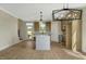 Open-concept kitchen with island, modern lighting, and access to outdoor space at 1403 Antioch Church Rd, Timberlake, NC 27583