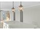 White kitchen island with waterfall countertop and modern pendant lighting above at 1403 Antioch Church Rd, Timberlake, NC 27583