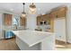 Spacious kitchen with a large white island, stainless steel appliances, and stylish pendant lighting at 1403 Antioch Church Rd, Timberlake, NC 27583