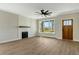 Bright living room features a shiplap fireplace, ceiling fan, and large windows offering scenic views at 1403 Antioch Church Rd, Timberlake, NC 27583