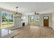 Open living space with fireplace, ceiling fan, and large windows for natural light at 1403 Antioch Church Rd, Timberlake, NC 27583