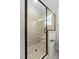 Shower features neutral tile and pebble floor; glass door at 1403 Antioch Church Rd, Timberlake, NC 27583