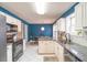Stylish kitchen with granite countertops, white cabinets, stainless steel appliances and a dine-in area at 200 Lindell Dr, Apex, NC 27539
