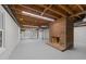 Partially finished basement space with fireplace, painted floor, and utility access at 2108 Rangecrest Rd, Raleigh, NC 27612