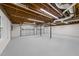 Unfinished basement space with utility hookups, painted floor and exterior door access at 2108 Rangecrest Rd, Raleigh, NC 27612