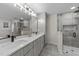 Modern bathroom featuring double sinks, sleek vanity, and glass-enclosed shower for a spa-like experience at 2108 Rangecrest Rd, Raleigh, NC 27612