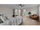 Comfortable bedroom features a ceiling fan, natural light, closet, and connecting bathroom and walk-in closet at 2108 Rangecrest Rd, Raleigh, NC 27612