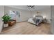 Bright bedroom featuring a ceiling fan, natural light from the large window, and stylish decor at 2108 Rangecrest Rd, Raleigh, NC 27612