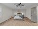 Bright bedroom featuring a ceiling fan, natural light from the large window, and stylish decor at 2108 Rangecrest Rd, Raleigh, NC 27612