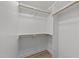 Walk in closet with built in shelving and wood closet rods for clothing storage at 2108 Rangecrest Rd, Raleigh, NC 27612