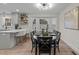 Well-lit dining area featuring modern decor, a bay window, and seating for six at 2108 Rangecrest Rd, Raleigh, NC 27612