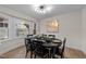 Cozy dining area with modern chandelier, neutral walls, and wood-look flooring at 2108 Rangecrest Rd, Raleigh, NC 27612