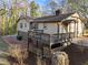 Two-story home featuring a chimney, brick details and an elevated deck at 2108 Rangecrest Rd, Raleigh, NC 27612